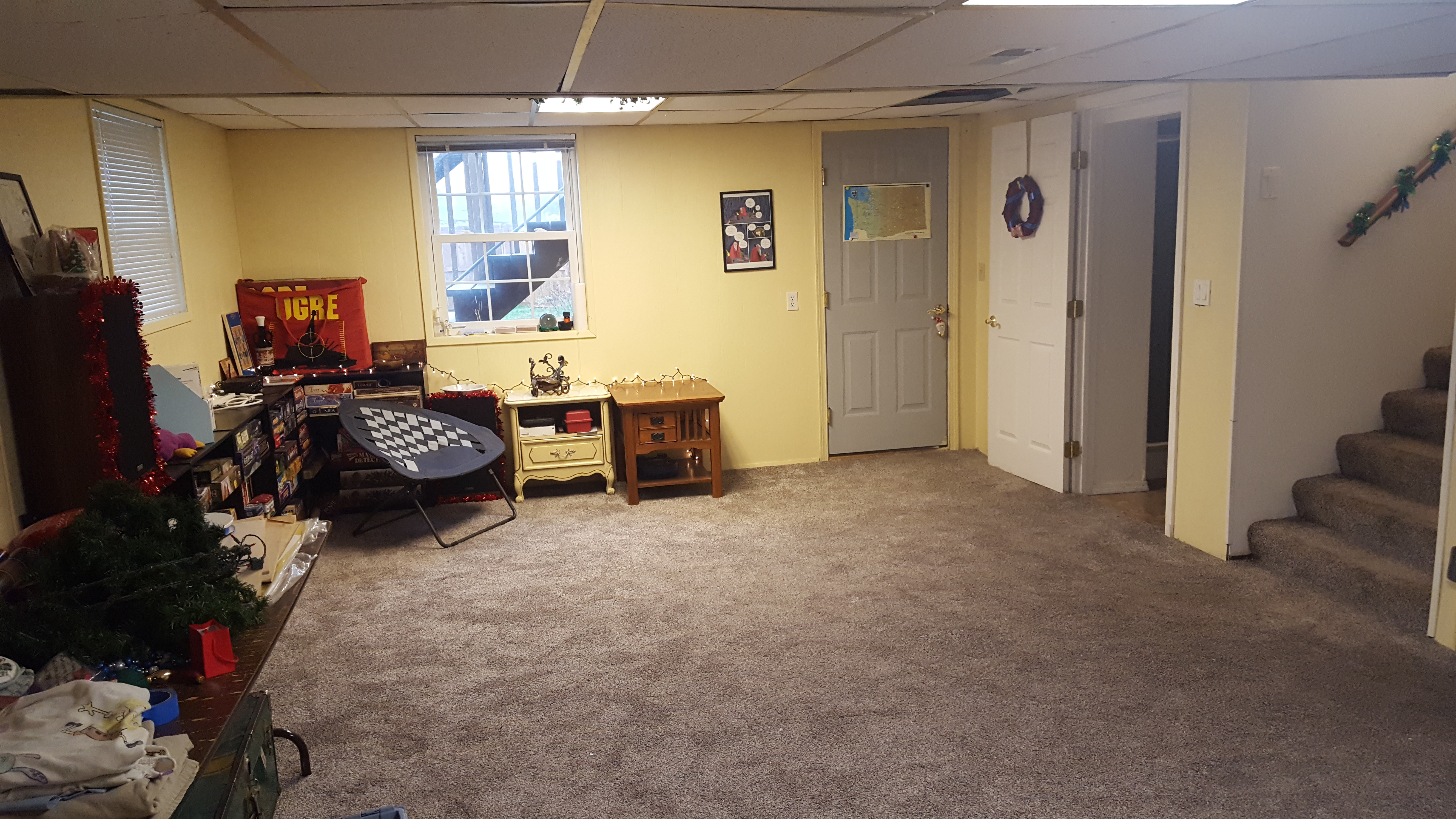 The basement in 2021. It's clean and carpeted and not really decorated very much beyond some garland and a wreath.