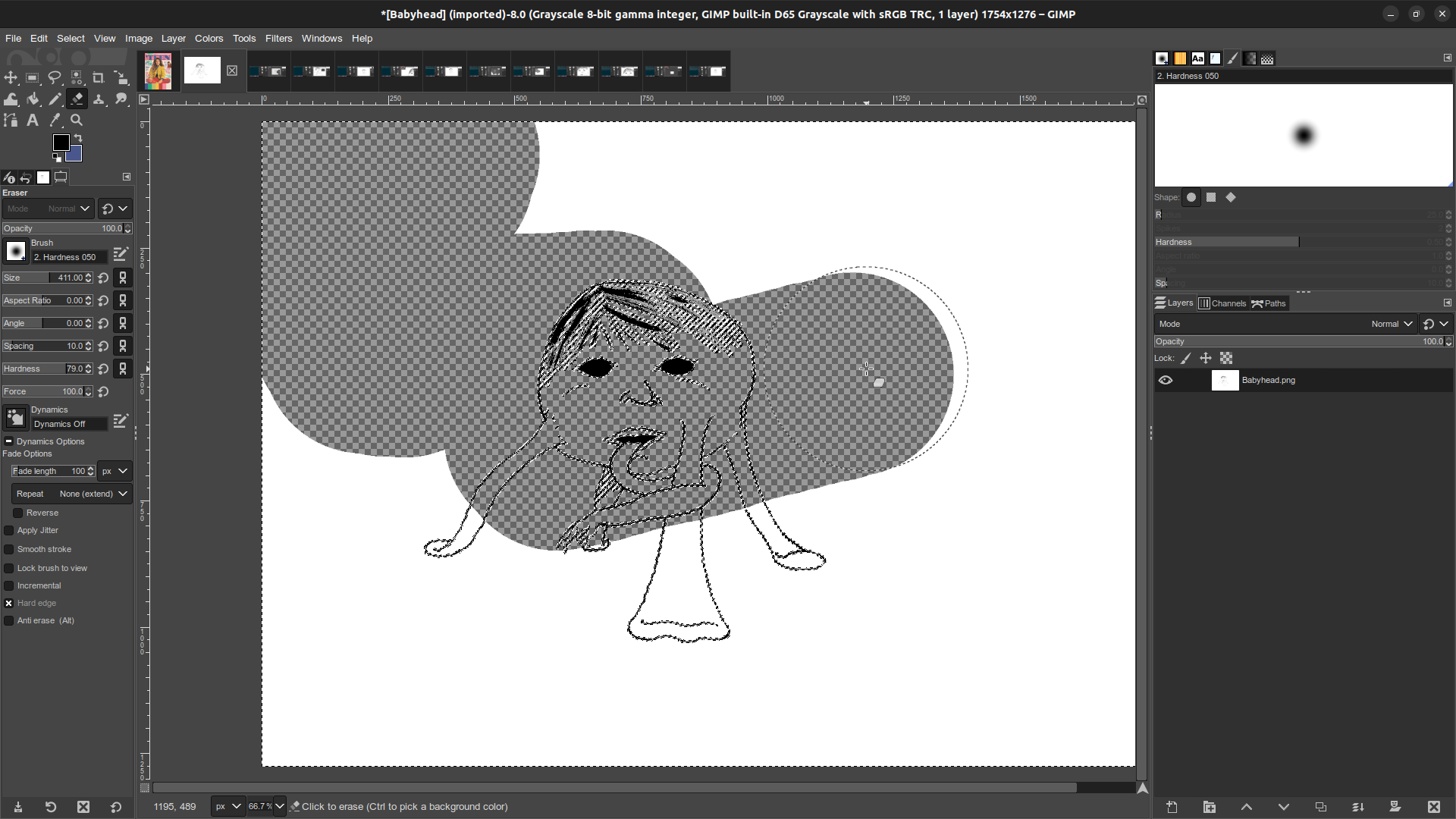 Gimp window in which the Babyhead monster illustration is open. The eraser tool is in the midst of zig-zagging across the image, erasing all of the white and revealing the checkerboard pattern that indicates transparency.